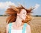 Adorable young girl shake hair in the field