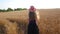 Adorable young girl in summer wheat field with straw hat 4K faceless. Woman with long blonde hair on countryside sunset.