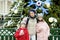 Adorable young girls and their mom having wonderful time on traditional Christmas market