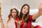 Adorable young woman eating pizza and fooling around. Positive sisters having fun and enjoying favorite fast food..