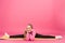 adorable youngster doing split on fitness mat, isolated