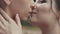 Adorably attractive couple kiss each other. Close up shot.