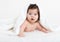 Adorably baby lie on white towel in bed. Happy childhood and healthcare concept