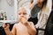 Adorably Precious Cute Little Blond Toddler Boy Showing Off His New Hair Style after Getting His First Hair Cut and Eating Candy