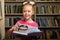 adorale cute child girl using magnifying glass for better reading books