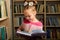 adorale cute child girl using magnifying glass for better reading books