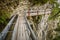 Adrenaline walking trail following historic irrigation channel on the cliffs Bisse du Ro close to Crans Montana