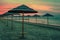 Adriatic coast sunset with beach umbrellas