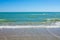 Adriatic Sea coast view. Seashore of Italy, summer sandy beach with clouds on horizon.