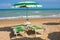 Adriatic Sea coast view. Seashore of Italy, summer umbrellas on sandy beach with clouds on horizon.