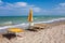 Adriatic Sea coast view. Seashore of Italy, summer umbrellas on sandy beach with clouds on horizon.