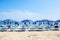 Adriatic Sea coast view. Seashore of Italy, summer umbrellas on sandy beach with clouds on horizon.