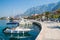 Adriatic sea shore with small leisure boats inside the harbor of Makarska City