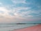 Adstract color of pink beach in blue sky brith sunset at the beach. dramatic gray cloudy sky above sea water