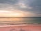 Adstract color of pink beach in golden sunset at the beach. dramatic gray cloudy sky above sea water