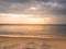 Adstract color of yellow beach in golden sunset at the beach. dramatic gray cloudy sky above sea water