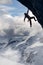 Adult adventurous man Rock Climbing a steep rocky cliff.