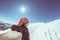 Adult alpin skier with beard, sunglasses and hat, taking selfie on snowy slope in the beautiful italian Alps with clear blue sky.