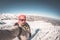 Adult alpin skier with beard, sunglasses and hat, taking selfie on snowy slope in the beautiful italian Alps with clear blue sky.