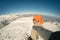 Adult alpin skier with beard, sunglasses and hat, taking selfie on snowy slope in the beautiful italian Alps with clear blue sky.