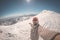 Adult alpin skier with beard, sunglasses and hat, taking selfie on snowy slope in the beautiful italian Alps with clear blue sky.