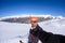 Adult alpin skier with beard, sunglasses and hat, taking selfie on snowy slope in the beautiful italian Alps with clear blue sky.