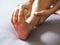 Adult Asian woman suffering with foot pain, sore feet and numbness
