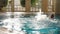 Adult bald man swimming backstroke with splash in indoor pool