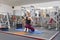 Adult beautiful female blonde doing stretching practicing yoga in gym