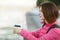 Adult beautiful redhead woman with bob haircut thinking drinking morning coffee in autumn city river pier