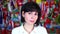 Adult brunette woman against the background of many flags