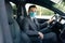 Adult businessman wearing medical mask in prevention for coronavirus and driving his car to work. Pandemic. Citizens