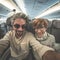 Adult caucasian couple taking selfie inside plane. Fish eye view from below. Concept of people traveling, natural light.