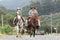 Adult and child rider on horseback in Ecuador