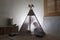 Adult and child sitting in a teepee in the nursery.