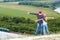 Adult and child standing on a mountaintop near river.