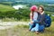 Adult and child standing on a mountaintop near river. Mother w