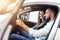 Adult couple choosing new car in showroom