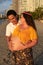 Adult couple expecting a baby while husband caresses the belly of his pregnant Latina wife