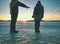 Adult couple holding hands walking on winter beach