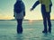 Adult couple holding hands walking on winter beach