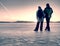Adult couple holding hands walking on winter beach