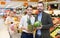 Adult couple with products in fruit department