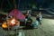 Adult couple relaxing in camping site by night. Adventure in National Park, South Africa. Burning camp fire and tent in the backgr