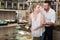 Adult couple standing with dried berries sold