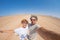 Adult couple taking selfie on gravel road in the Namib desert, Namib Naukluft National Park, main travel destination in Namibia, A