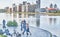 Adult couples dancing on embankment of Iset river over background of city buildings .