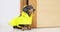 Adult dachshund sits patiently at door in yellow raincoat , waits go for walk