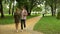 Adult dad walking with loving teen daughter in park, sharing his life experience