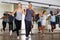 Adult dancing couples enjoying active boogie-woogie in modern studio